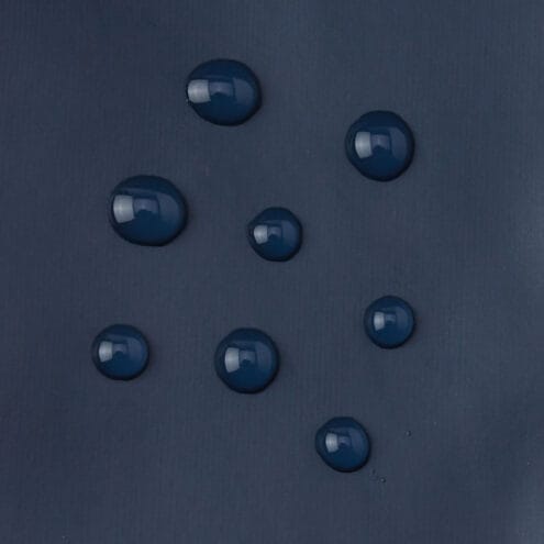 Närbild på textil av Reima Kura regnvantar (barn)