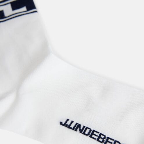 Närbild på logga på J.Lindeberg Percy Sock tubstrumpor (herr)